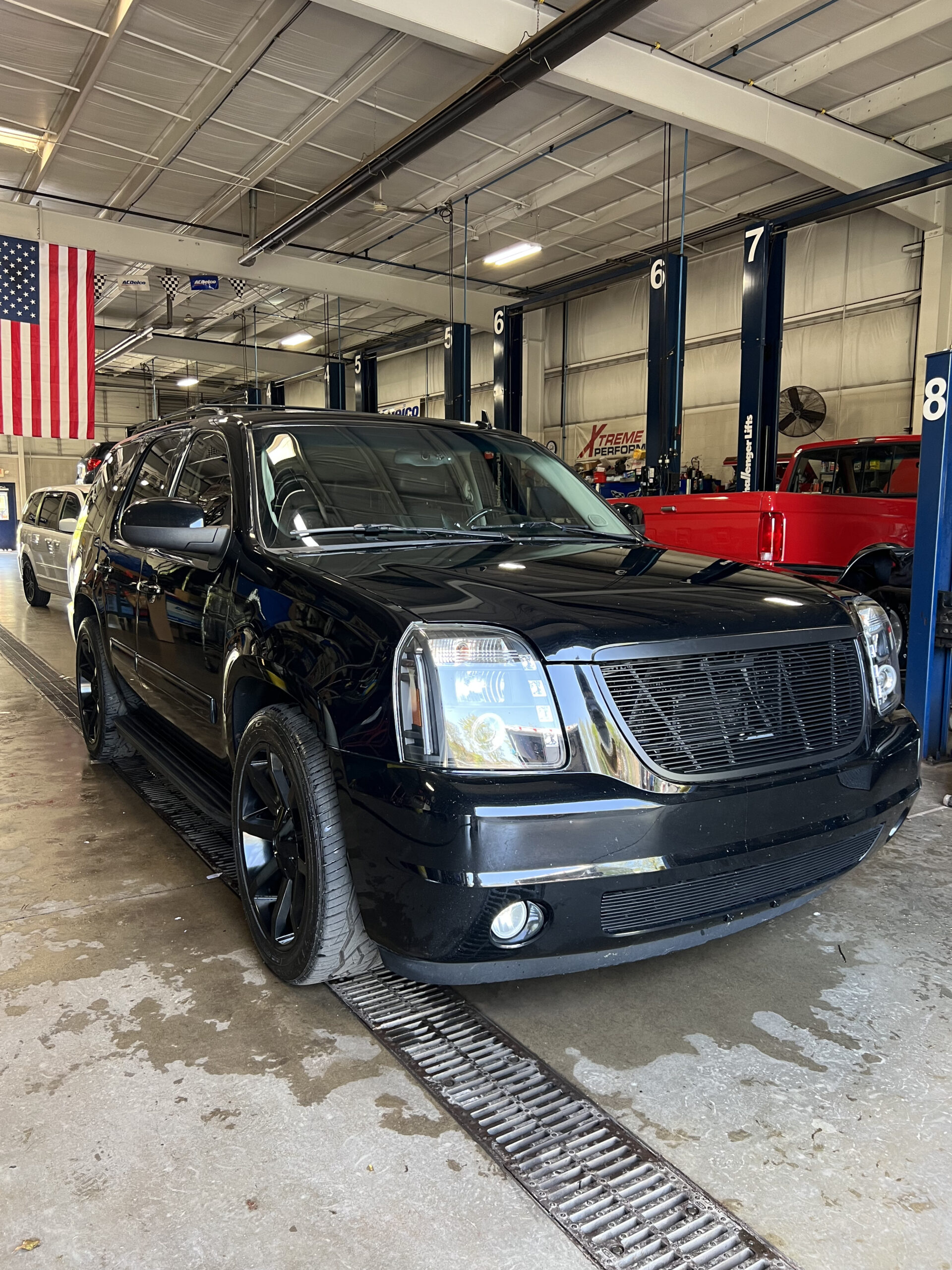 Glossy black SUV with swirl-free paint after correction and polishing